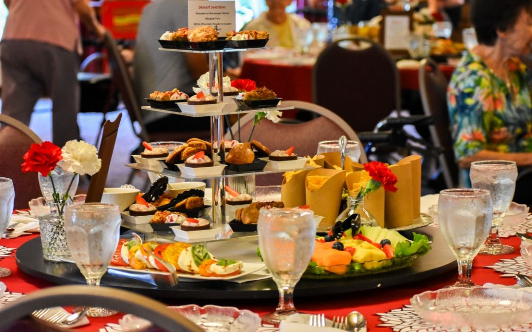 An elegant tiered service of bites and desserts at a Willow Brook Village courtyard event in Delaware, Ohio, illustrating the dining experiences offered to senior residents.